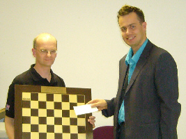 Andrew Moore (right) gives winner's cheque and trophy to Lawrence Cooper.