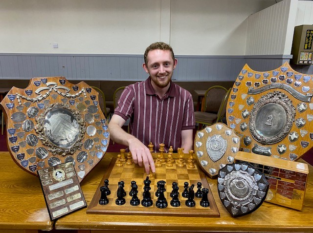 Kidderminster's Leading player surrounded by trophies